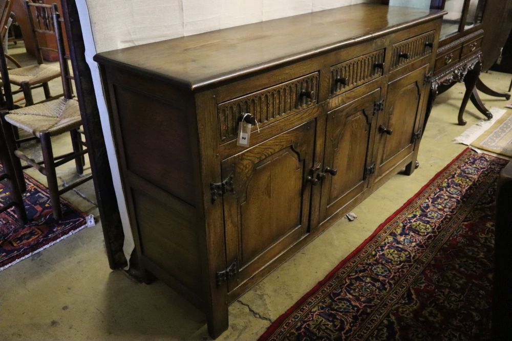 An 18th century-style oak refectory dining table, sideboard and four chairs, table 182 x 79cm height 76cm